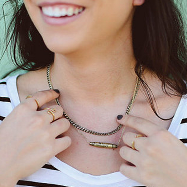 Brass necklace sits below neck 